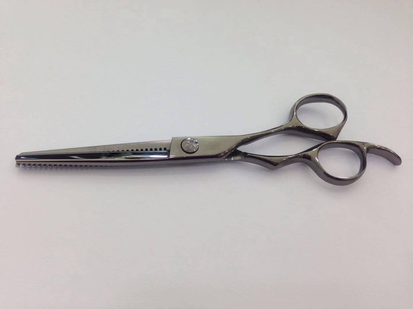 Barber scissor in pvd titanium black color.