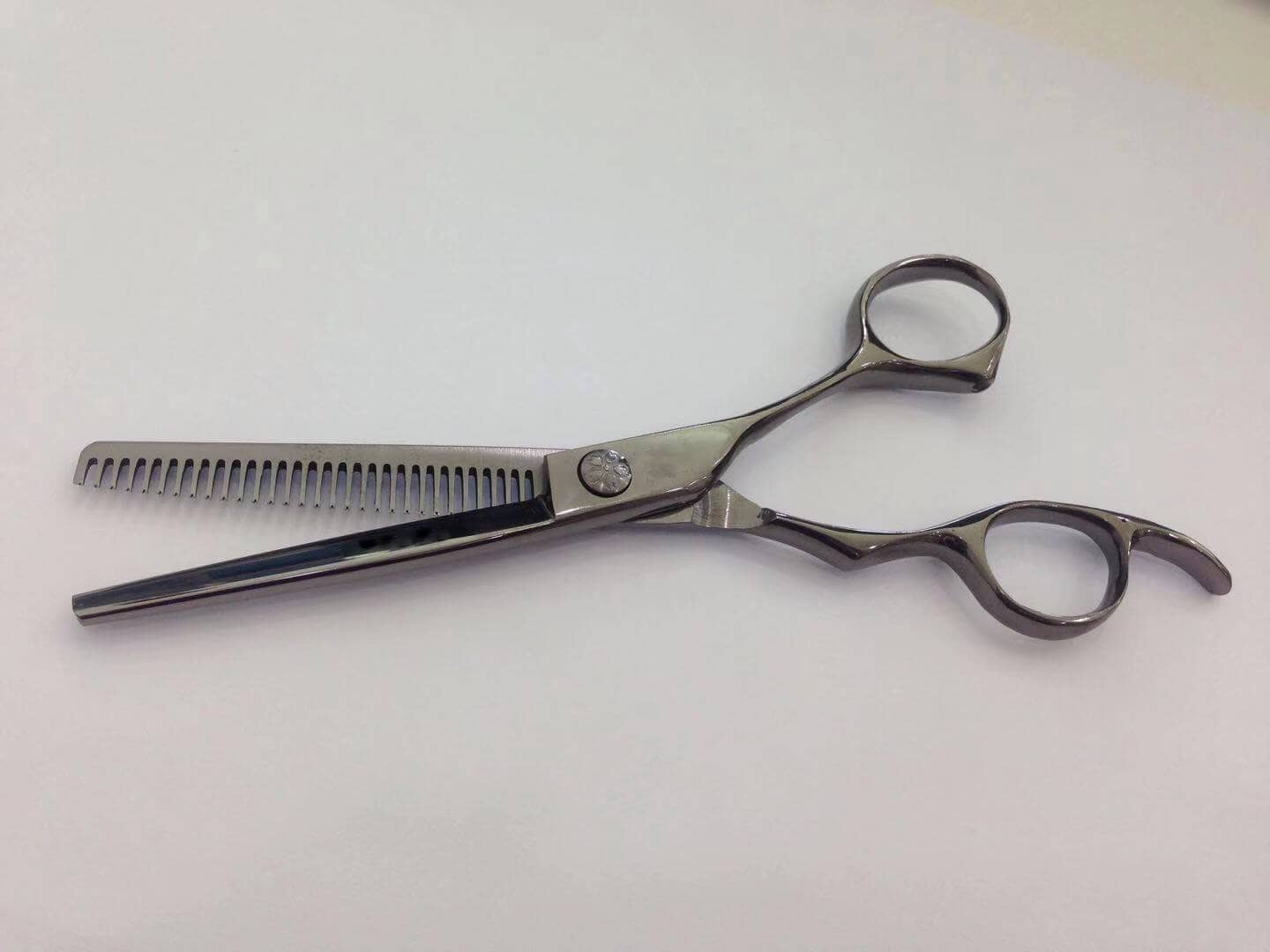 Barber scissor in pvd titanium black color.