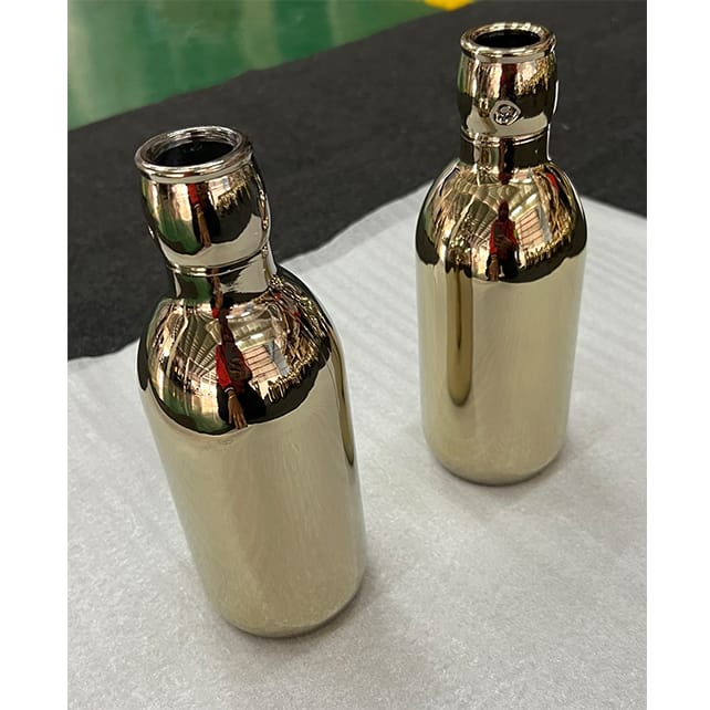 Glass bottle coated in pvd gold coating