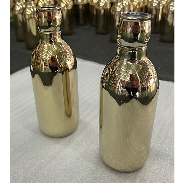 Glass bottle coated in pvd gold coating
